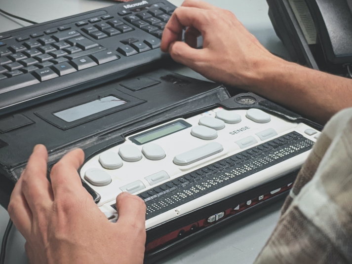 Blind man using a braille screen reader